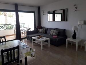 a living room with a couch and a table at Departamento Joelle in Puerto del Carmen