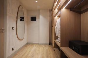 a dressing room with a mirror and a closet at Elite Bay Hotel Lalez Durres in Lalëz