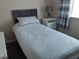 a bedroom with a large bed and a window at 3-Bed bungalow near Conwy valley close to Castle in Colwyn Bay