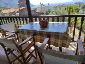 a table with a pumpkin sitting on top of a balcony at Kotrwnas Family Traditional Villa Seaview in Kótronas