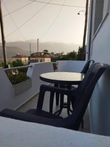 a table and two chairs sitting on a balcony at Yannis apartments in Georgioupolis