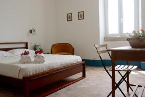 a bedroom with a bed and a table and chairs at Agriturismo Morani in Santa Severa