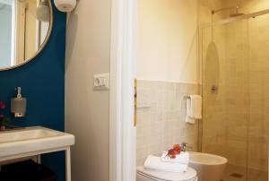 a bathroom with a toilet and a sink and a shower at Agriturismo Morani in Santa Severa +37 photos