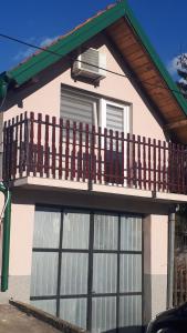 a house with a balcony on top of it at Apartman Dunja Banja Vrdnik in Vrdnik