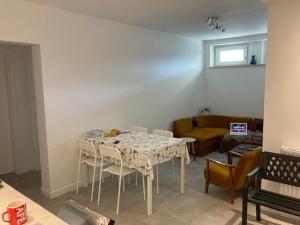 a room with a table and chairs and a couch at Guest House Ustka in Ustka +3 photos
