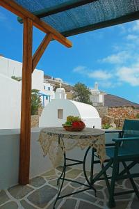 a table with a bowl of fruit on a balcony at Irene Rooms in Chora Folegandros