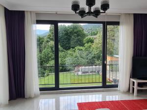 a living room with a large window with a view at KD Apartments in Kartepe