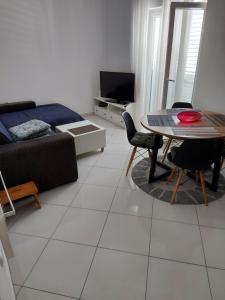 a living room with a couch and a table at Vita Style in Kaštela