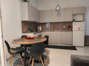 a kitchen with a table and chairs and a refrigerator at Vita Style in Kaštela