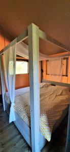 a bunk bed in a room with a bed frame at Safaritent Lodge 5 in Ruurlo