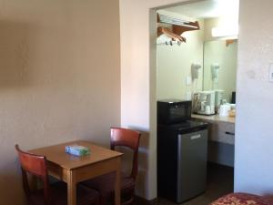 a kitchen with a table and a refrigerator at Economy Inn in San Francisco
