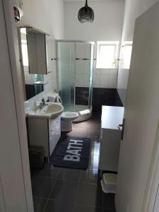 a bathroom with a sink and a toilet at Vita Style in Kaštela +17 photos