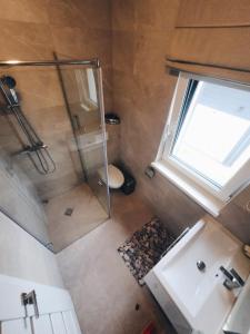 an overhead view of a bathroom with a shower and a toilet at Sesiu Vilos @ Kunigiskes in Palanga