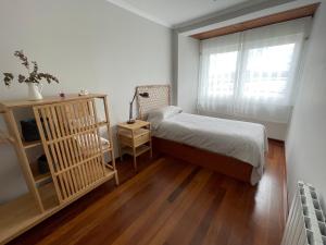 a small bedroom with a bed and a window at Apartamento A Tenencia in Sada