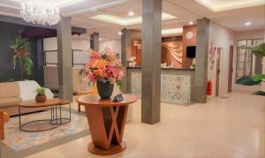 a living room with a vase of flowers on a table at SOWAN BOUTIQUE GUEST HOUSE in Ngadipuro