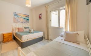 a bedroom with two beds and a window at Swim n Rest Apartment with pool in La Herradura