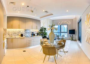 a kitchen and dining room with a table and chairs at Bay Central, Dubai Marina in Dubai