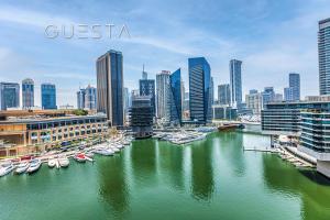 a group of boats in a river in a city at Bay Central, Dubai Marina in Dubai