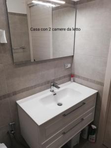 a bathroom with a white sink and a mirror at Fascino del Cilento in Caprioli +27 photos