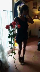 a woman in a dress standing next to a plant at Agriturismo Sentiero delle Fiabe in Sirolo