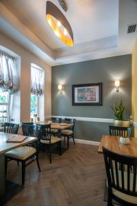 a dining room with wooden tables and chairs at Vila Emilia in Vrnjačka Banja