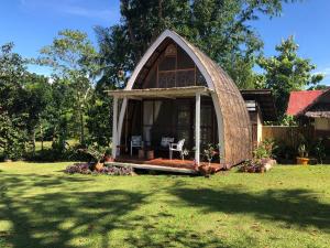 a gazebo in the yard of a house at The Cabins at LVF in Puerto Princesa City