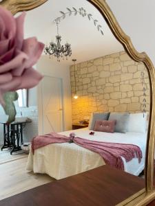a bedroom with a large bed with a large mirror at Apartamentos LA SOMERA in Alhama de Aragón