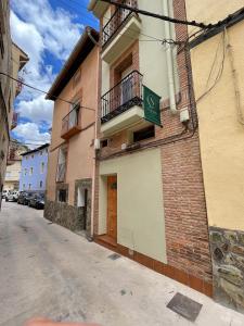 a building with a sign on the side of it at Apartamentos LA SOMERA in Alhama de Aragón