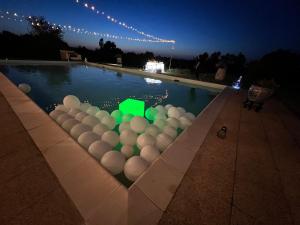 a pool with a bunch of balls in it at night at Casa Burraia in Abbadia di Montepulciano