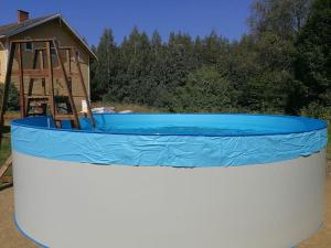 a large blue and white pool with a playground at Old village school in Kolkontaipale
