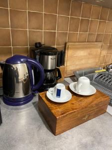 a counter top with two plates and a coffee pot at Appartement Rez de chaussée T2 centre-ville in Vendôme +2 photos