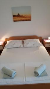 Postel nebo postele na pokoji v ubytování Apartmani Mileta