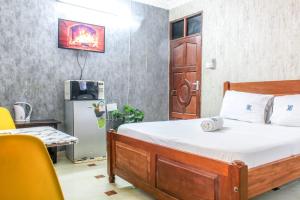 a bedroom with a bed and a desk and a tv at Sea Esta suite 47 in Mombasa