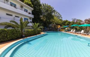 a swimming pool in front of a building at Bristol Hotel in Ischia