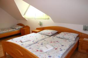 a bedroom with two beds and a window at Apartments Jožetov grič - FARM STAY in Podčetrtek