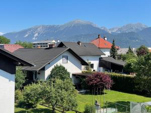 a group of houses with mountains in the background at ANMARI Apartment & Rooms in Radovljica
