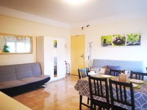 a living room with a couch and a table at Seaside BLISS in Agia Triada
