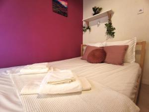 a bedroom with two beds with towels on them at Seaside BLISS in Agia Triada