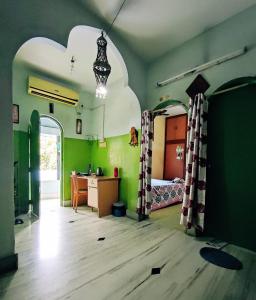 a room with a bedroom with a bed and a desk at Peaceful Living in Kolkata