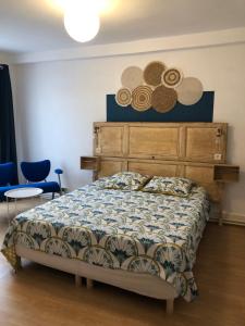 a bedroom with a bed and two hats on the wall at L'étape II in Varzy