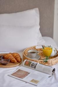 a breakfast table with a basket of eggs and croissants at Hotel Admiral in Budva