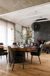 a dining room with a wooden table and chairs at White Pearl in Hermanus