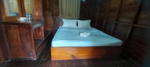 a small bed with two hearts on it in a room at Mind House Bungalow in Nam Theun