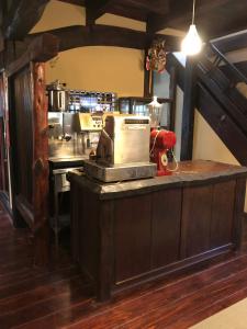 a kitchen with a counter with a machine on it at Guest House Dohei in Kamakura