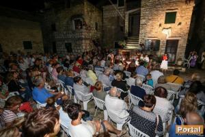 a crowd of people sitting in chairs in a room at Stone house Castellum in Kaštela