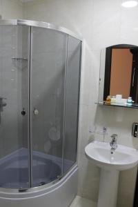 a bathroom with a shower, sink, and toilet at Sobkoff in Khmelnytskyi