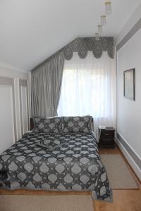 a neatly made bed in a small room at Sobkoff in Khmelnytskyi