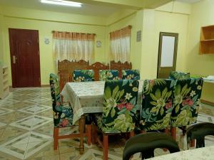 a dining room with a table and two chairs and a table and chairsktop at Soc Transient House by GPR in Baguio