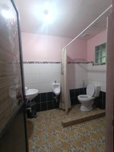 a bathroom with a toilet and a sink at Soc Transient House by GPR in Baguio