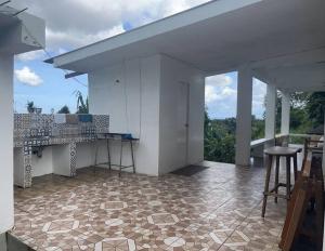 a kitchen with a counter and a table on a floor at Beautiful 3 bedroom vacation home with view. in Zamboanga